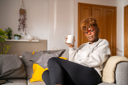 Black Woman Drinking A Cup Of Tea At Home.