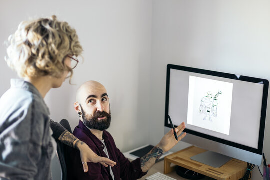 Graphic designer showing his work to his girlfriend