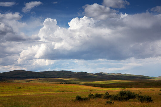 Summer clouds build up over the prairies .
