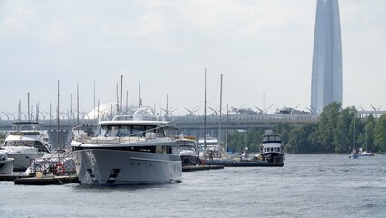 Yacht parking, A marina lot, yacht is moored at the quay. Yachts and boats at the pier. Panorama of the city on the beach. View from the pleasure boat.