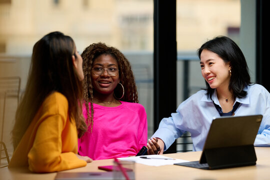 Female coworkers speaking during break