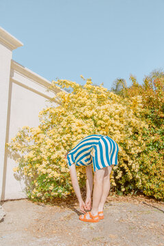 Man faceplants into flower bush