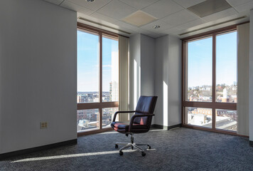 Single Office Chair in Empty Office in Downtown office building