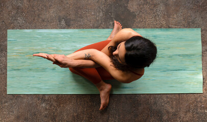 Young Woman Practicing Yoga in Cow Pose
