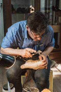 Male Artisan shoemaker in his workshop 
