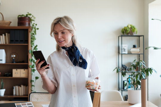 Business woman texting on the phone at office