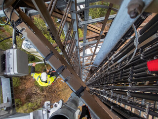 5G fiber optic technician on a telecommunication tower, hights working