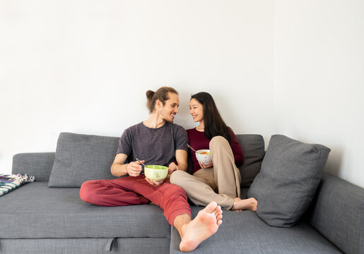 Couple Relaxing Together At Sofa
