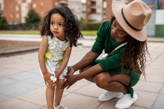 young black woman with her daughter in a park