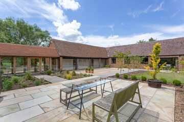 Garden and patio area of converted farm buildings made into housing.