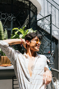 Smiling Young Man Relaxing In Roof Garden