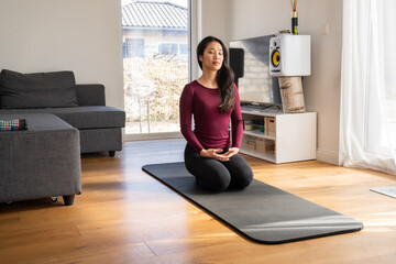 Asian Woman Meditating At Home