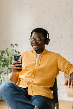 Man Looking At Memes On His Mobile Phone