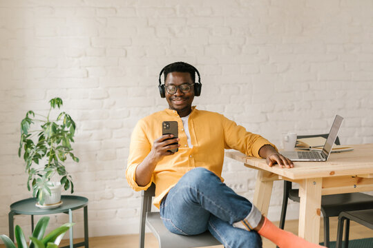 Man Looking At Memes On His Mobile Phone
