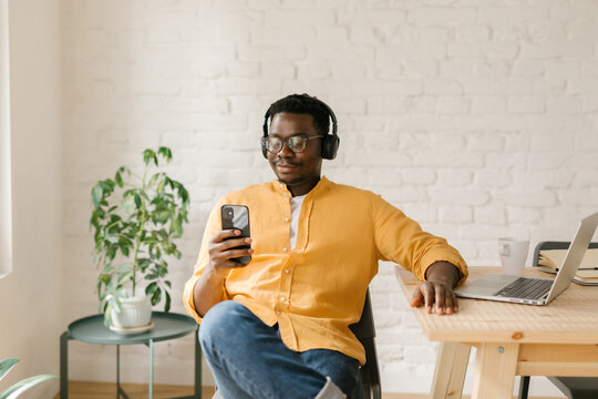 Man Looking At Memes On His Mobile Phone