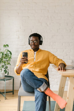 Man Looking At Memes On His Mobile Phone