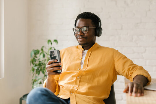 Man Looking At Memes On His Mobile Phone