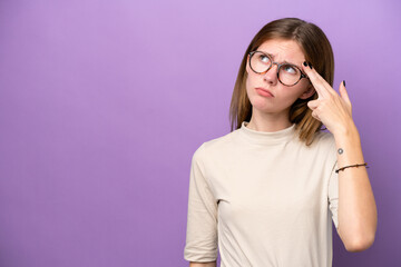 Young English woman isolated on purple background with problems making suicide gesture