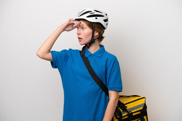Young English woman with thermal backpack isolated on white background doing surprise gesture while looking to the side