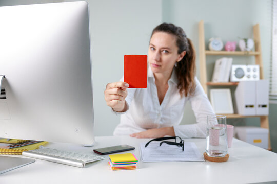 Young businesswoman showing a red card