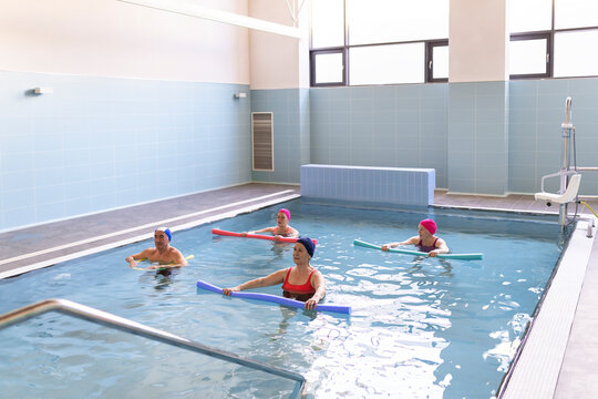 Senior people exercising in pool