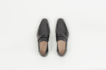 Beautiful black leather male fashion penny loafer isolated on white background top view