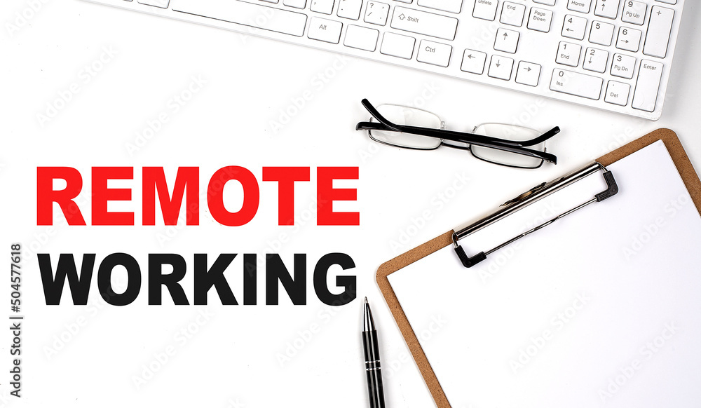 Poster remote working text written on white background with keyboard, paper sheet and pen