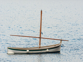 Gozzo, the Italian Riviera fishing boat, armed with lateen sail - 504579220