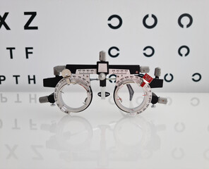 Glasses for selection of lenses in the frame in background is ophthalmologist table