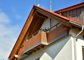 Balkon mit Metall-Geländer und lasierten Holzplanken an einem Wohnhaus