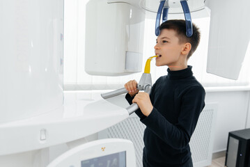 A seven-year-old boy had a computed tomography of the jaw, a circular image of the jaw in modern dentistry. Prevention of caries, prosthetics and dental treatment. Radiology, panoramic scanner.