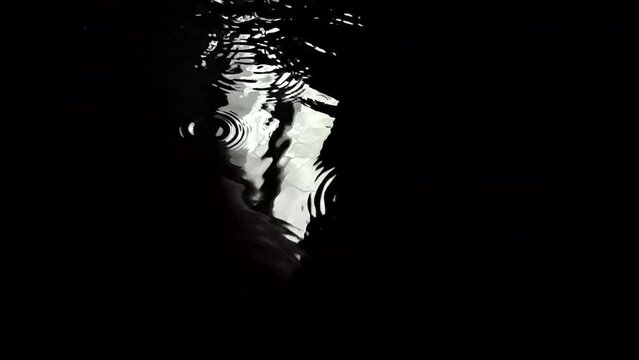 Morning sun rays from window in black water reflection wit rain drops in super slow motion cinematic video. Filmed on high speed cinematic camera at 1000 fps. High quality FullHD footage