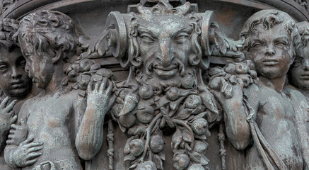 Old light lamp stand with many sculptures and top statue of Victory goddess with Laurel wreath for...