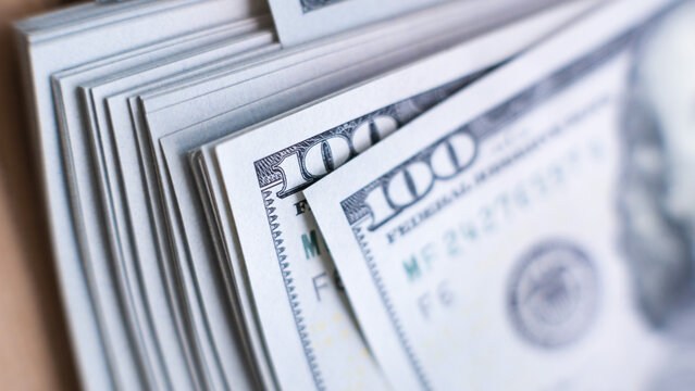 close-up of a stack of $ 100 bills of a new design. selective focus, macro photography