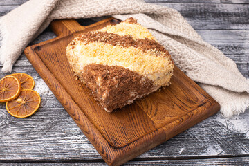 Cake, on a white wooden background, wooden plate