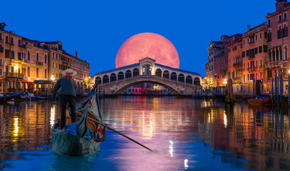 Gondola near Rialto Bridge with full moon rising - Venice, Italy 