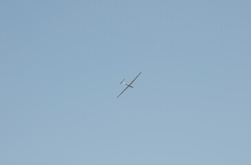 glider gliding on the blue sky background
