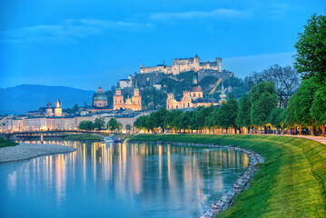 Salzburg bluehour with Festung Hohensalzburg fortress and reflection of night city lights. Austria