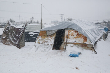 Refugee tents covered with heavy snow.