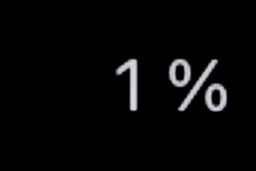 White pixel number - one, 1 percent on display, screen of smartphone, tablet, black background -...