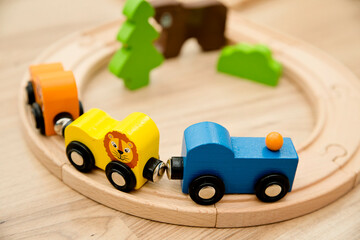 Wooden railway and train with animal wagons on wooden floor. Nostalgia toy from childhood.