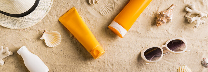 Sunscreen sunblock lotion on sandy beach - obrazy, fototapety, plakaty