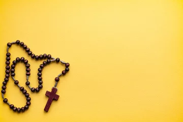 Fotobehang Rosary for prayer on a yellow background. catholic hail Christian © Alena