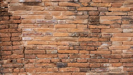 The background of an old brown brick wall in an ancient Thai temple.