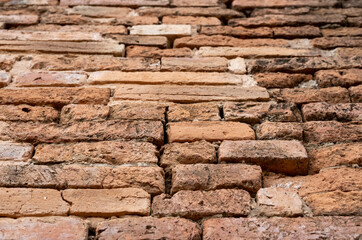 Blurred background of an old brown brick wall in an ancient Thai temple.