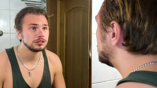Adult man mad at himself and screaming in front of mirror, inner frustration