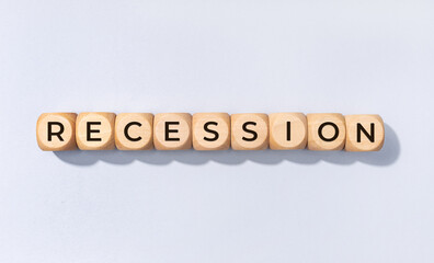 Recession word on wooden block isolated on gray background