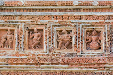 Terracotta decorations on the walls at Pratapeswar Temple at Kalna, West Bengal, India. Terracotta is a brownish-red clay that has been baked and is used for making things.