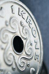 1 Danish krone coin close-up. National currency of Denmark. Vertical money illustration for news about economy or finance. Bank and loan. Savings and interest. Macro