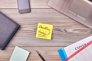 Deadline today handwriting with office stationery items. Top view flat lay.